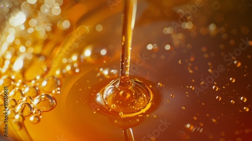 Golden honey being poured with rich, detailed texture and bubbles, highlighting the luscious, natural sweetness and viscosity.