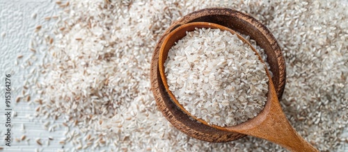 Psyllium husk in a bowl with a spoon on a white background. with copy space image. Place for adding text or design