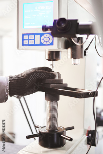 Hardness tester in laboratory, measures strength of metal.