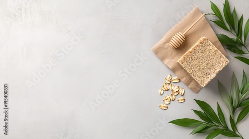 Handmade soap with oatmeal, shea butter, and honey arranged alongside craft paper, showcasing a natural beauty theme