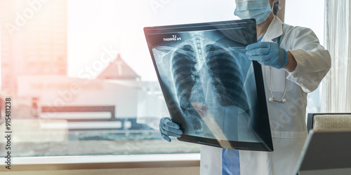 Doctor diagnosing patient’s health on asthma, lung disease, COVID-19 or bone cancer illness with radiological chest x-ray film for medical healthcare hospital service