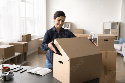 Small business owner, female warehouse worker preparing parcel for dispatch, sending box through reliable courier company. Workflow of online store merchant using sales platform, electronic commerce