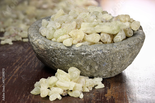 Al-Hojari Boswellia sacra frankincense resin from Oman in a stone bowl on wooden table