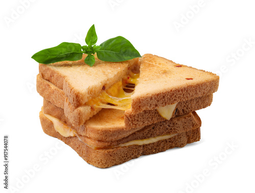 Pieces of toasted bread with melted cheese and basil isolated on white