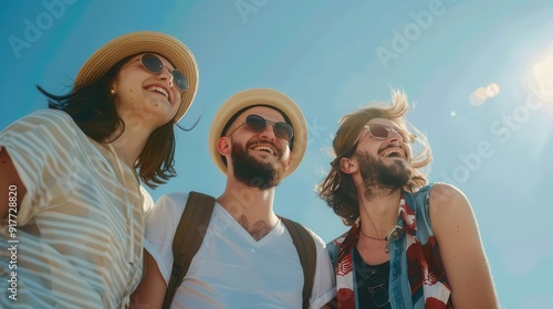 Group of friends smiling and laughing together on a sunny day.