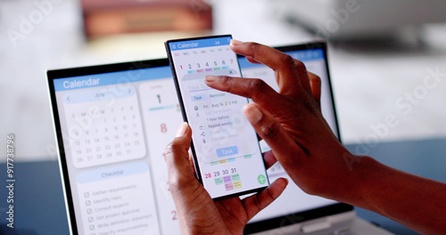 African Woman Organizing Appointment Schedule Using Cellphone And Calendar