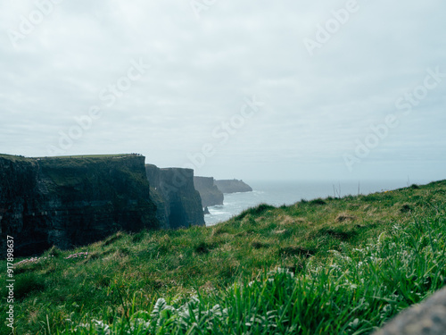 Scenic View of Cliffs Overlooking Ocean Waves on a Cloudy Day