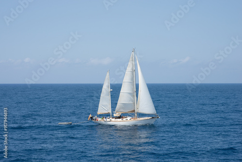 Yacht sailing in the wind on blue calm water, summer landscape