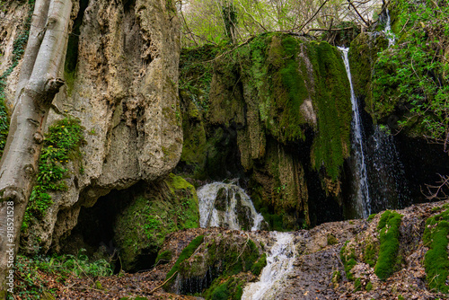 Serene waterfall cascading through mossy cliffs at Beli Izvorac, Serbia