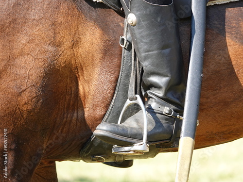 Horse riding boot from the time of 1812. Leather officer's boot of black color, stirrup, spurs, horse ammunition of brown color. Rider of the Napoleonic cavalry.