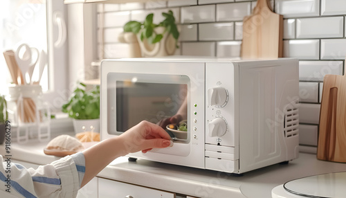 Woman's Hands Closing Microwave Oven Door And Preparing Food At Home