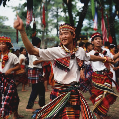 Man in traditional clothing dances with a group of people.