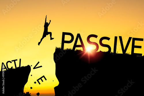 Silhouette of man jumping from active cliff to passive cliff for change from active income to passive income concept.