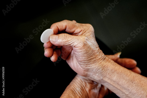 Old People Hand holding bread in a Holy communion.