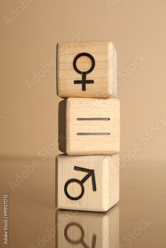 Gender equality concept. Cubes with male and female symbols on beige background