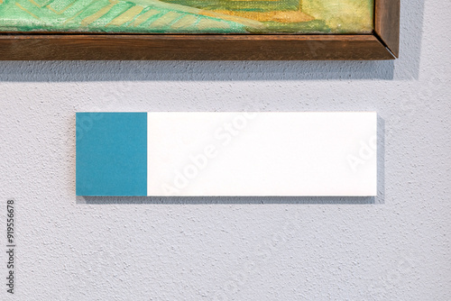 Museum art gallery painting artwork label author name picture photo description empty rectangle blank card plaque hanging on a wall object detail front view, frontal shot extreme closeup modern design