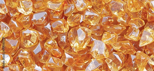 Close up of a pile of yellow topaz gemstones. The gemstones are shiny and reflect light. The background is white.