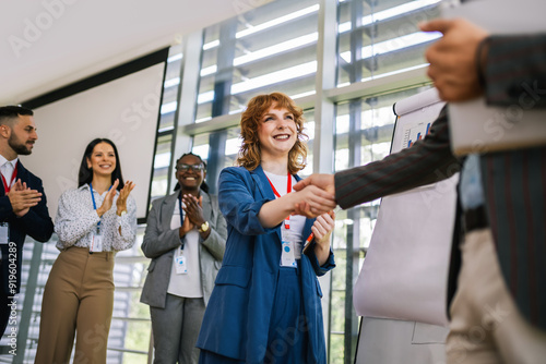 Business man from Human Resource congratulates the new ginger employee of their company after the job interview.