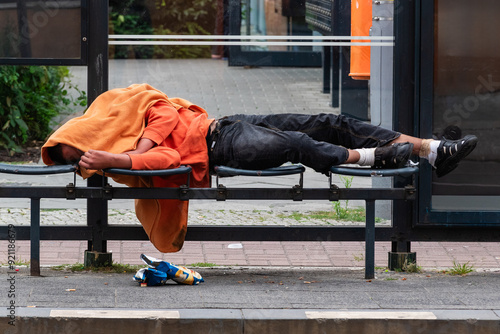 Homless Man sleeping in a Tram Station, A drunk person lies in a tram stop and sleeps off his intoxication