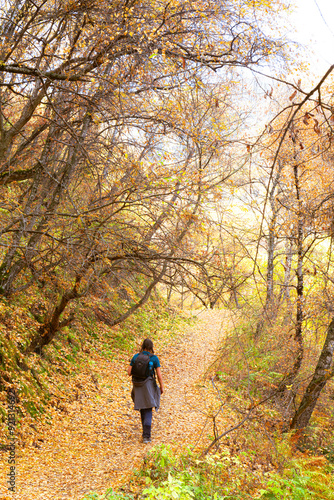 Dagestan, Russia - 23 October 2020: Sights of Dagestan. Tourist walking on the path passing colorful trees in autumn