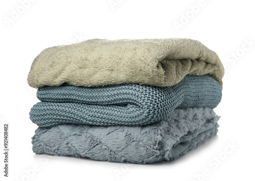 Different soft folded blankets on white background