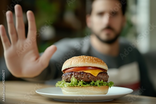 Man Resisting Temptation of Delicious Hamburger.