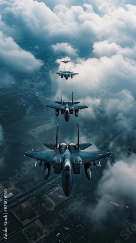 Four military aircraft soar in formation amidst thick clouds, showcasing aerial prowess and coordination