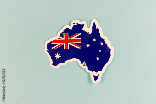 Australia Map Sticker with National Flag on Light Blue Background with Copy Space.