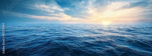 Tranquil seascape with a blue sky and gentle waves.