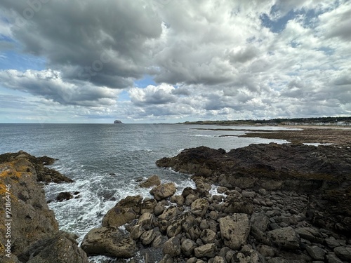 Rocky beach on the coast of Firth of Forth with a view to Bass Rock near North Berwick, Scotland, United Kingdom, August 2023