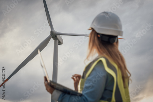 An Engineer is thoroughly Evaluating the Performance of Wind Turbines within the broader context of a Sustainable Renewable Energy Landscape, contributing to advancements in renewable technology