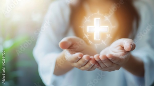 A person holds their hands open, cupped upwards, with a glowing white cross symbolizing healing, faith, and hope. The soft background suggests a peaceful and caring atmosphere.