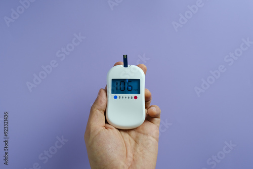 Woman's hands checking diabetes and hyperglycemia with digital blood sugar meter. Healthcare and medical concept 