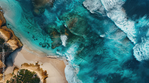 Aerial drone view of a stunning coastal landscape with turquoise waters and sandy beaches, waves gently lapping at the shore.