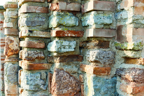 Stone wall background. Old texture ribbed wall made of thin calcined brick known as plinfa - plinfa used in Byzantium and Ancient Rus construction