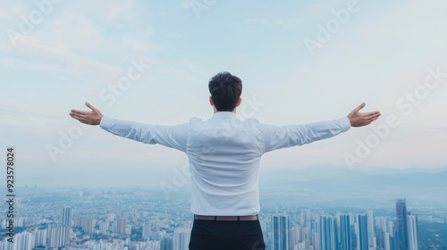 Businessman Embracing Freedom Above Cityscape.