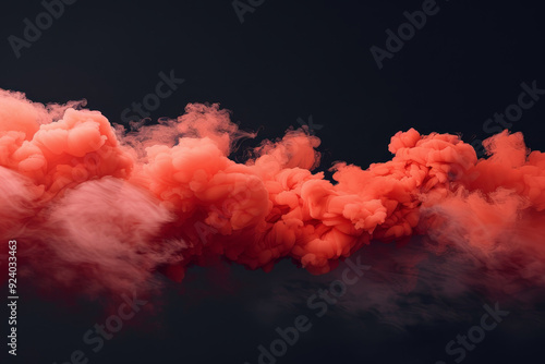 A dramatic burst of red smoke expands against a solid black background, creating a striking contrast. The swirling, cloud like formation captures the dynamic motion and intensity of the explosion.