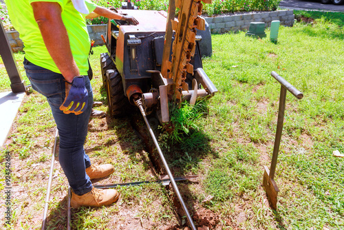 Installing underground communications networks using horizontal directional drilling machines before trenchless laying of fiber optic cables