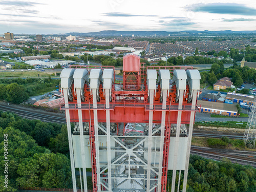 Transporter bridge counterweight system towering over urban landscape