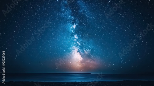 Starry night sky over the ocean with the Milky Way prominently visible.