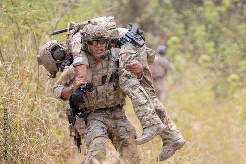 oldier carried the injured fellow from the mission in the forest