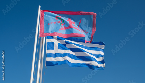 Greece. Greek flag and the flag of the island of Spetses during the 1821 Greek Revolution waving on blue sky