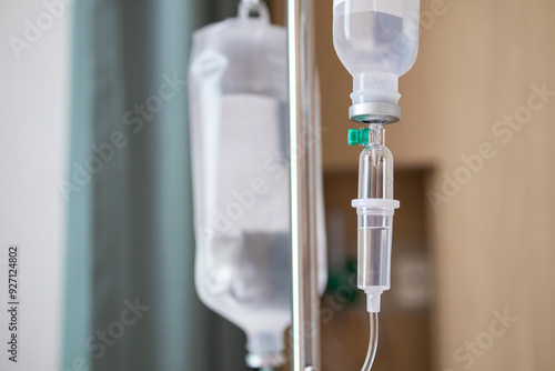 Close up medical intravenous IV drip in hospital background