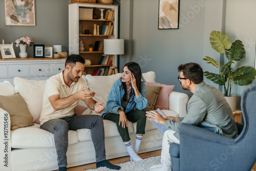 Worried couple arguing about their problems with marriage counselor at home