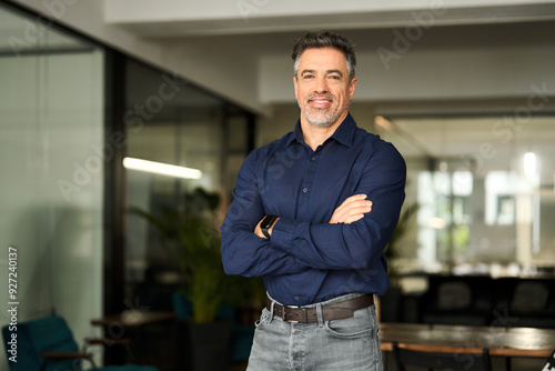 Happy confident professional business man of middle age standing in office. Mature 50 years old business owner, company manager, smiling senior ceo executive, older corporate leader at work. Portrait.