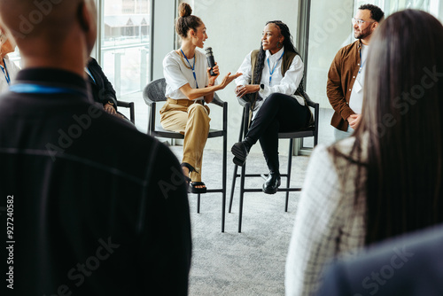 Business panel discussion with professionals debating in a modern conference setting