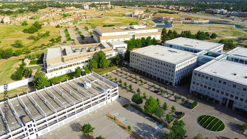 Office campus buildings with multi-level garages rooftop parking lots incorporate shade structure in Westlake, Texas, high-performance business workspace suburb Dallas-Fort Worth, aerial view