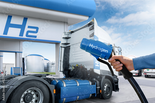 Hand with H2 nozzle on a background of hydrogen fuel cell semi truck with H2 gas cylinder onboard. Eco-friendly commercial vehicle concept