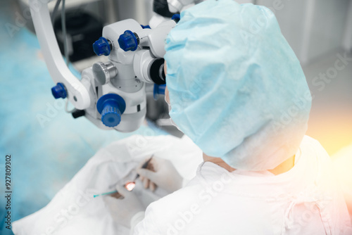 Lasik treatment operation, laser vision correction. Doctor examines fundus in microscope, patient under sterile cover