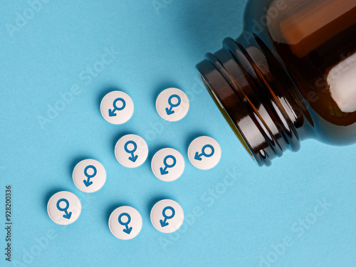 Medical hormone pills with male symbol spilling out of the bottle.